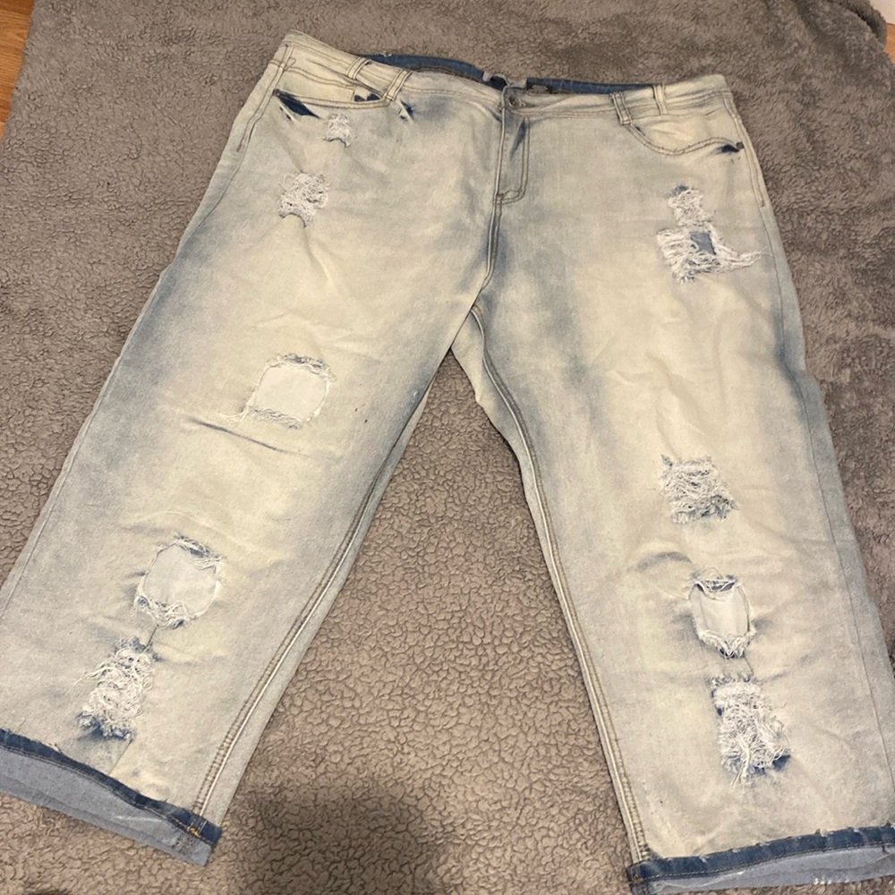 Light blue jean capris with rips in the from and the back